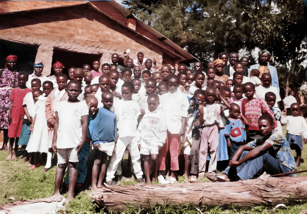 A large group of children and adults gathered outside a church building in Kenya.