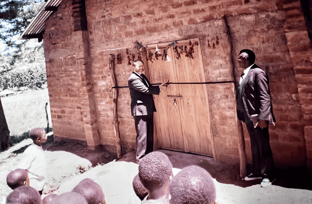 Missionary Jerry Daniels and Pastor David Shikambi Luvai cutting a ribbon during the grand opening of a new church facility in Kenya.