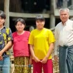 Pastor Maung and three members of his family standing together outside in Myanmar.